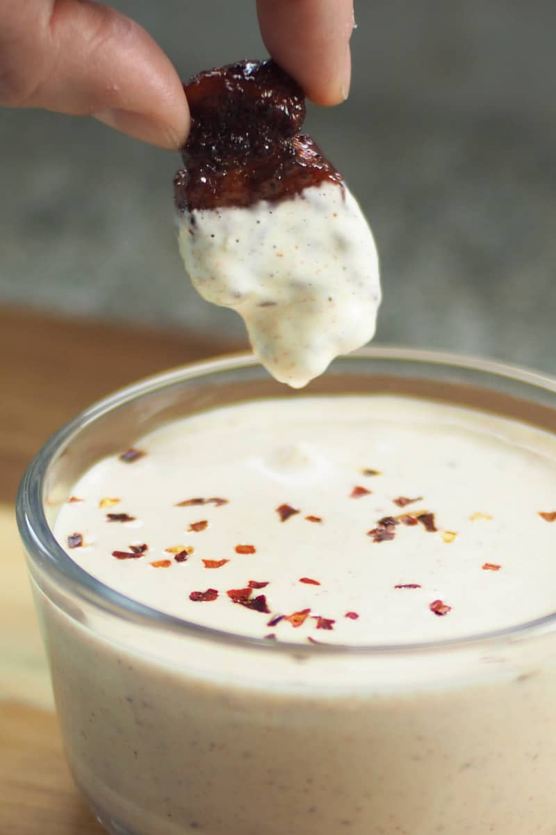 Dipping a pork belly bite into some Alabama white bbq sauce.