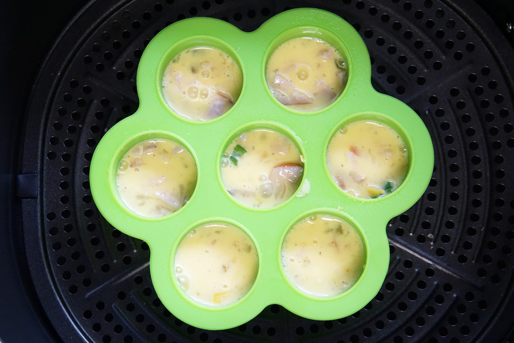Egg bite mold full of scrambled egg mixture