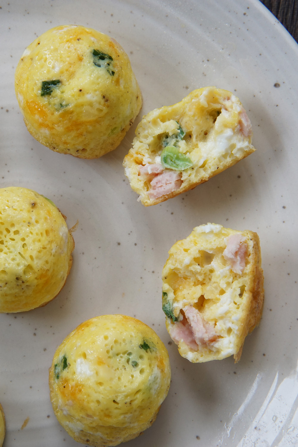 Egg bites on a plate and one cut in half