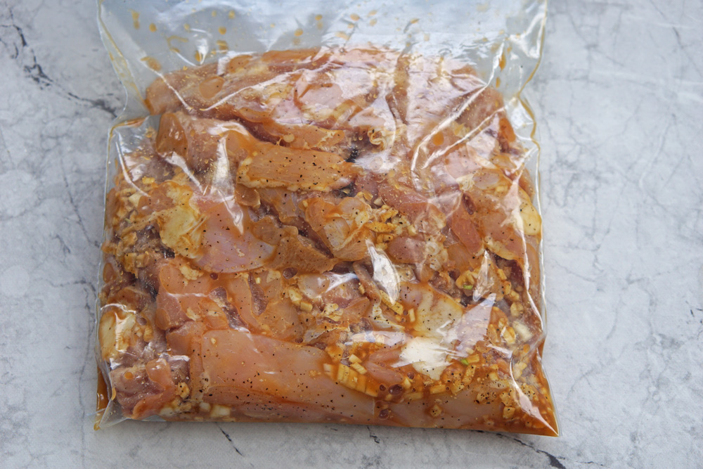 chicken marinating in a resealable bag