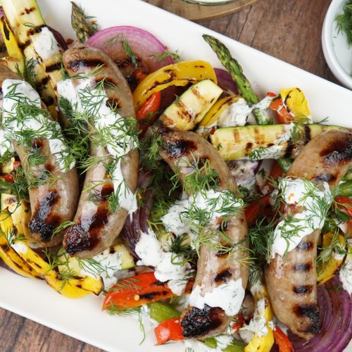 Grilled brats and veggies with dill sauce